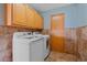 Functional laundry room featuring washer, dryer, and cabinet storage at 32800 E 137Th Way, Brighton, CO 80603
