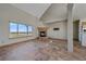 Open living room featuring fireplace, large window, and tile flooring at 32800 E 137Th Way, Brighton, CO 80603