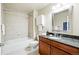 Well-lit bathroom featuring decorative tile, bath tub, vanity, and granite countertop at 1975 N Grant St # 810, Denver, CO 80203