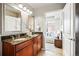 Bathroom featuring double sinks, granite countertop, and a view to the main bedroom at 1975 N Grant St # 810, Denver, CO 80203