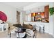 Cozy dining area with modern table and chairs, open to the updated kitchen with granite counters and stainless appliances at 1975 N Grant St # 810, Denver, CO 80203