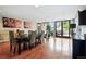 Bright dining room with wood floors, large windows, and a view of the outside patio area at 1975 N Grant St # 810, Denver, CO 80203