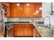 Galley kitchen with stainless steel appliances, dark wood cabinets and granite countertops, combining style with functionality at 1975 N Grant St # 810, Denver, CO 80203