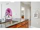 The kitchen island features granite countertops, a stylish faucet, and contemporary decor, blending functionality with modern design at 1975 N Grant St # 810, Denver, CO 80203