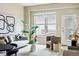 Bright living room features large window, comfortable seating and stylish décor, creating an inviting and modern space at 1975 N Grant St # 810, Denver, CO 80203