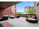 Inviting outdoor patio featuring comfortable lounge furniture and views of the surrounding community buildings at 1975 N Grant St # 810, Denver, CO 80203