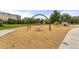 Community playground featuring a swing set, wood chips, and views of nearby buildings at 1975 N Grant St # 810, Denver, CO 80203