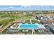 Aerial shot of community pool, club house, and park with lush landscaping at 2105 Bellcove Dr, Castle Pines, CO 80108