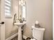 This bathroom has a pedestal sink, modern fixtures, and neutral wall color at 2105 Bellcove Dr, Castle Pines, CO 80108