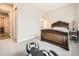 Comfortable bedroom with soft carpet, a stylish bed frame, and an adjacent bathroom entrance at 2105 Bellcove Dr, Castle Pines, CO 80108