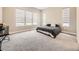 Bright bedroom featuring large windows with modern shades, soft carpet, and neutral walls at 2105 Bellcove Dr, Castle Pines, CO 80108
