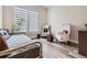 Bright bedroom featuring hardwood floors, two stylish chairs and large windows with horizontal blinds at 2105 Bellcove Dr, Castle Pines, CO 80108