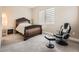 Cozy bedroom with a stylish bed frame, soft carpet, and a comfortable reading area at 2105 Bellcove Dr, Castle Pines, CO 80108