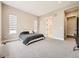 Spacious bedroom featuring soft carpet, neutral walls, and an adjacent bathroom entrance at 2105 Bellcove Dr, Castle Pines, CO 80108
