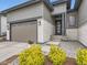 Inviting home front with stone accents, modern door, professional landscaping, and attached garage at 2105 Bellcove Dr, Castle Pines, CO 80108
