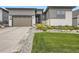 Charming home exterior with well-maintained landscaping, stone accents, and a two-car garage at 2105 Bellcove Dr, Castle Pines, CO 80108