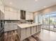 Bright kitchen featuring a center island, modern appliances, hardwood floors, and sliding doors at 2105 Bellcove Dr, Castle Pines, CO 80108