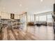 Open-concept living room with hardwood floors, large windows, modern lighting, and fireplace at 2105 Bellcove Dr, Castle Pines, CO 80108