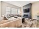 Bright living room showcasing a modern fireplace, cozy sectional sofa, and hardwood floors at 2105 Bellcove Dr, Castle Pines, CO 80108