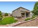 Beautiful backyard featuring a well-maintained lawn, patio with seating, and mature landscaping at 286 Western Sky Cir, Longmont, CO 80501