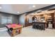 Basement featuring a wet bar with seating and a pool table, perfect for entertaining at 286 Western Sky Cir, Longmont, CO 80501