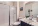 Well-lit bathroom featuring shower with glass doors, a single sink vanity, and a toilet at 286 Western Sky Cir, Longmont, CO 80501