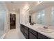 Bright bathroom with double vanity, walk in shower, and a large walk-in closet providing ample space at 286 Western Sky Cir, Longmont, CO 80501