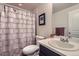 Bathroom with single vanity, toilet, and shower/tub combo featuring a geometric patterned curtain at 286 Western Sky Cir, Longmont, CO 80501