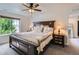Bedroom with ceiling fan, large window view, and stylish dark wood bedroom set at 286 Western Sky Cir, Longmont, CO 80501