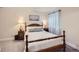 Bedroom featuring a wood frame bed, cozy lamps, soft carpet, and a gray chevron curtain at 286 Western Sky Cir, Longmont, CO 80501