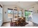 Cozy dining area with a wooden table, six chairs, and a view of the patio at 286 Western Sky Cir, Longmont, CO 80501