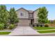 Two-story home with a two-car garage, stone accents, and manicured landscaping at 286 Western Sky Cir, Longmont, CO 80501