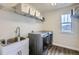 Well-organized laundry room with modern washer and dryer, plus a sink and storage at 286 Western Sky Cir, Longmont, CO 80501