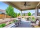 Covered patio with outdoor seating, ceiling fan, and decorative rug, ideal for relaxation at 286 Western Sky Cir, Longmont, CO 80501