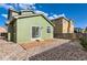 Backyard view featuring a patio, low-maintenance rock landscaping and green siding at 10117 Wyandott N Cir, Thornton, CO 80260