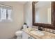 Charming powder room featuring granite countertop and decorative backsplash at 10117 Wyandott N Cir, Thornton, CO 80260