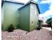Green home with a low-maintenance gravel yard and various windows at 10117 Wyandott N Cir, Thornton, CO 80260