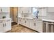 Updated kitchen featuring white cabinets, stainless steel appliances, and a modern sink at 10117 Wyandott N Cir, Thornton, CO 80260