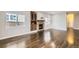 Spacious living room featuring hardwood floors, a fireplace, and large windows at 10117 Wyandott N Cir, Thornton, CO 80260