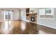 Living room featuring hardwood floors, fireplace, and access to the backyard at 10117 Wyandott N Cir, Thornton, CO 80260