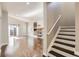 Open concept layout with hardwood floors, a fireplace, and staircase at 10117 Wyandott N Cir, Thornton, CO 80260