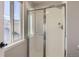 Bright bathroom showcasing a tiled shower with glass sliding doors at 10117 Wyandott N Cir, Thornton, CO 80260