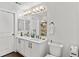 Bright bathroom with double sinks and a large mirror with decorative lighting at 4100 Albion St # 314, Denver, CO 80216