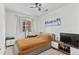 This bedroom features a fan, large window and modern decor at 4100 Albion St # 314, Denver, CO 80216