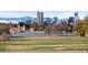 Scenic park view of Denver skyline with lake and mountains in background on a beautiful sunny day at 4100 Albion St # 314, Denver, CO 80216