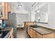Modern kitchen showcasing a stainless steel refrigerator and a breakfast bar view to the dining room at 4100 Albion St # 314, Denver, CO 80216