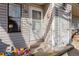 Detailed entrance of unit 106 with a white storm door and wood-tone trim at 8701 Huron St # 5-210, Thornton, CO 80260
