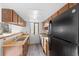 Functional kitchen with a skylight, ample cabinetry, and modern appliances at 8701 Huron St # 5-210, Thornton, CO 80260