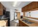 Bright kitchen features wood cabinets, a double sink, and a laundry area at 8701 Huron St # 5-210, Thornton, CO 80260