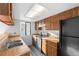 Well-lit kitchen featuring a new range and stainless steel sink at 8701 Huron St # 5-210, Thornton, CO 80260